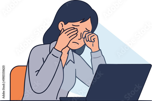 Woman rubs eyes stressed at computer desk indoors