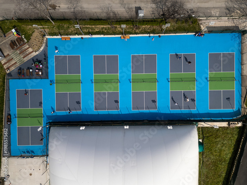Top Down Aerial View of People Playing Pickleball on Blue Courts