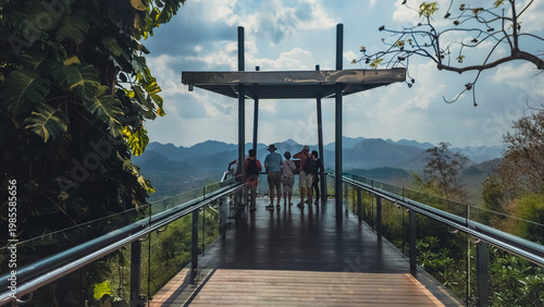 Tourists standing on mountain viewpoint platform looking at scenic landscape, Group of people enjoying panoramic view from observation deck in nature travel destination, Hellfire pass Thailand