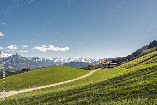 Scenic View from Sigiswang over Green Alpine Meadows to Famous Peaks of Allgaeu Alps including Rubihorn, Hoefats and Hohes Licht along Heilbronner Hoehenweg, Bavaria, Southern Germany