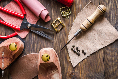 cobbler tools in workshop dark background top view