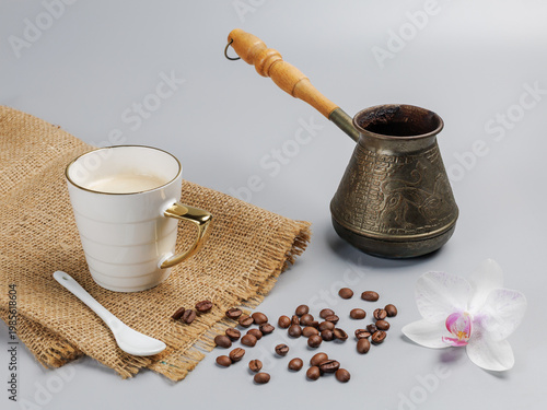 Cup of coffee, a cezve with roasted coffee beans.