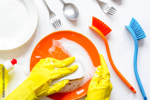 concept of woman washing dishes on white background