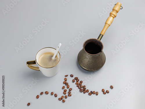 Cup of coffee, a cezve with roasted coffee beans.