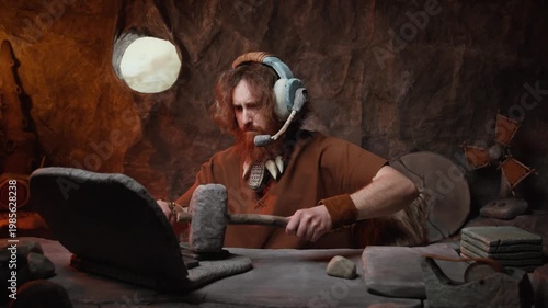 Caveman customer service agent with headset working on a stone laptop in his cave office.