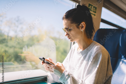 Travel woman using smart phone during her train ride