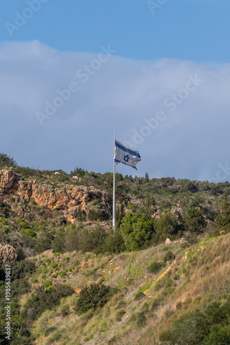 The flag of Israel on the Carmel mountain near Zichron Ya'acov on a sunny day in Israel.
