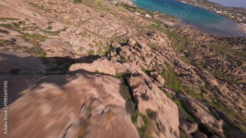 A cinematic FPV drone flight over unique smooth rock formations at Kolymbithres Beach on Paros island, Greece. Natural sculpted stones create an unusual landscape, perfect for travel, nature 