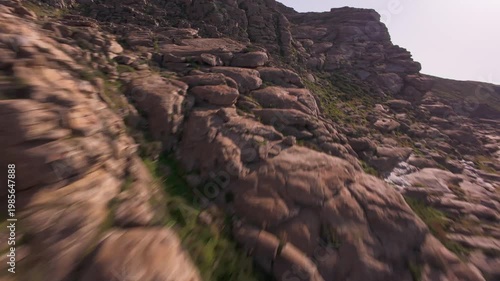 A cinematic FPV drone flight over unique smooth rock formations at Kolymbithres Beach on Paros island, Greece. Natural sculpted stones create an unusual landscape, perfect for travel, nature 