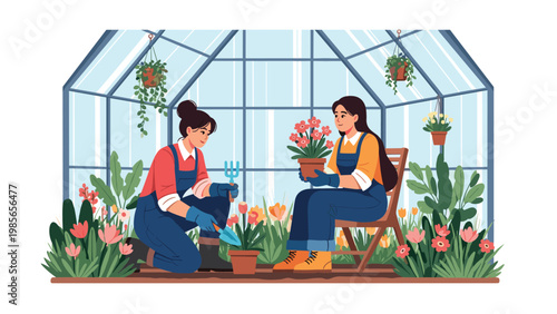 Two women in overalls gardening together in a greenhouse filled with blooming flowers and plants in pots on a sunny day.