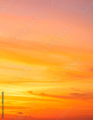 Vibrant Orange and Pink Sunset Sky with Wispy Clouds Over Horizon