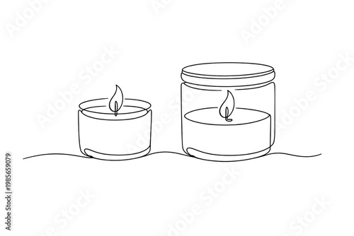 Two lit candles in glass containers on white background flames