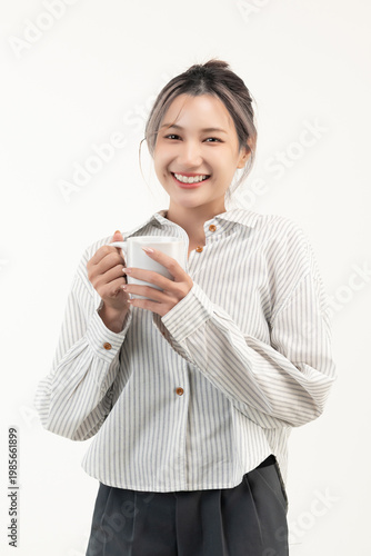 Happy young asian woman holding a cup coffee isolated on white background.