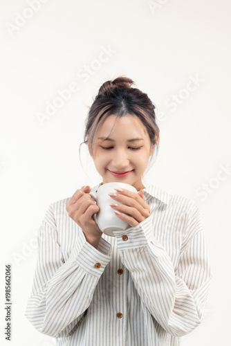 Happy young asian woman holding a cup coffee isolated on white background.
