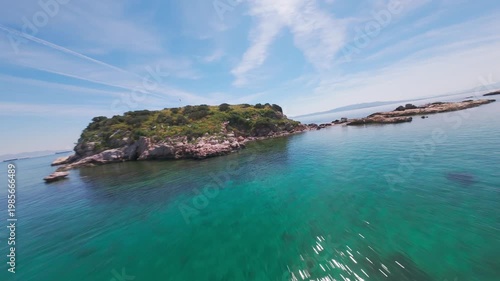 A cinematic FPV drone flight over small Greek islands featuring empty sandy beaches, seagulls flying above the sea, and a traditional fishing boat. 