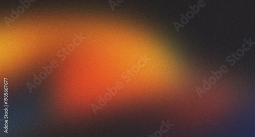Warm abstract grainy background with rich orange and yellow tones fading into a darker shade, perfect for autumn or cozy themes.
