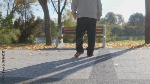 Senior man enjoying autumn views from a park bench