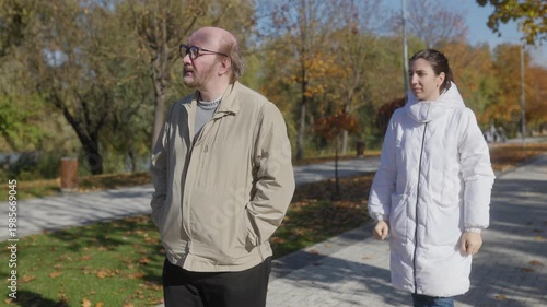 Compassionate elder care shown in autumn park with senior man