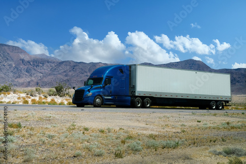 semi truck driving on highway through  nature and mountains. Commercial vehicle transport for logistics and freight shipping.