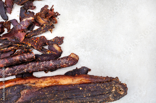 South African biltong and dry wors on light background with copy space