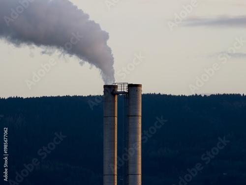 Фотография Vast white emissions from industrial stacks dominate landscape highlighting envi