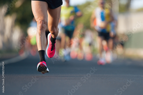 Marathon running race, people feet on city road, runners run urban marathon in the the city