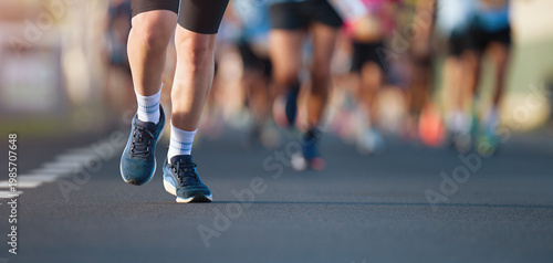 Marathon running race, people feet on city road, runners run urban marathon in the the city