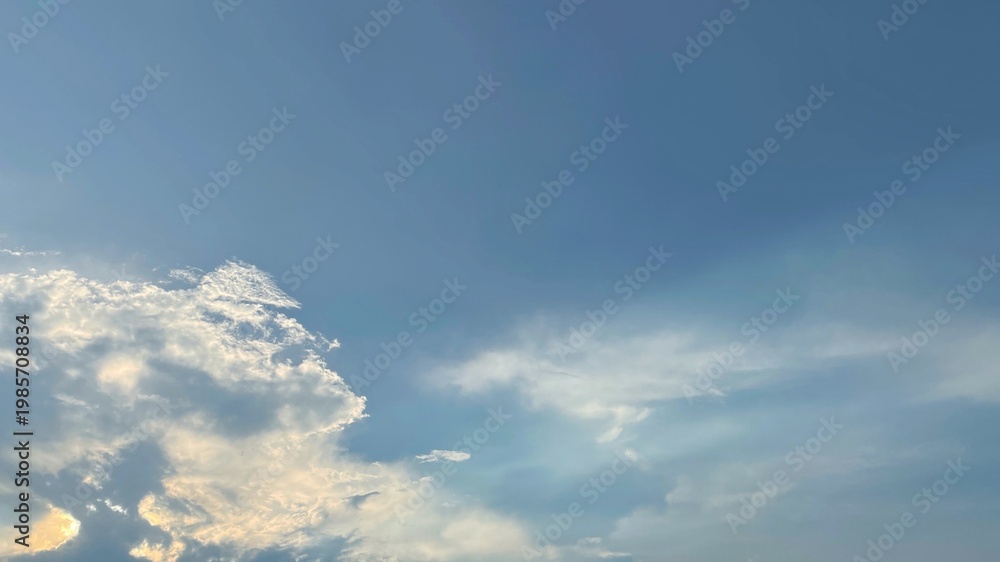 Fototapeta premium Blue Sky with Clouds Background Late Afternoon Light Subtle Rainbow Effect Copy Space