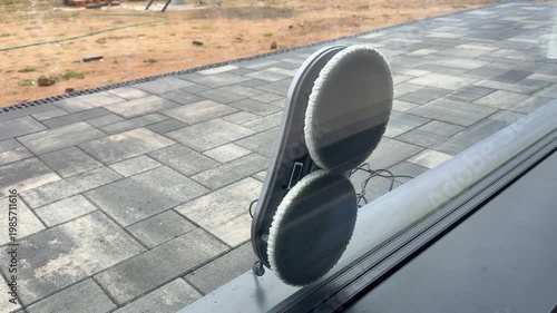 Vacuum cleaner robot washing glass window. Robot assistant cleaning windows