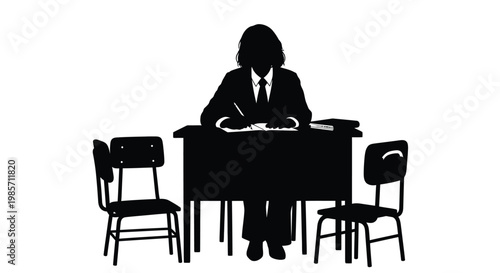 Silhouette of people sitting under a tree at sunset with mountains in background
