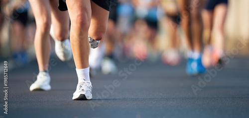 Marathon running race, people feet on city road, runners run urban marathon in the the city