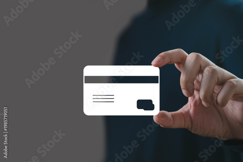Hand holding a credit card icon representing digital payment, online banking and secure financial transactions. fintech technology, cashless economy, e commerce payment and modern banking services.