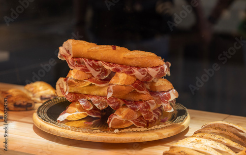 Traditional Spanish sandwich with cured Serrano ham on crusty bread, a classic lunch snack or tapas, Spain