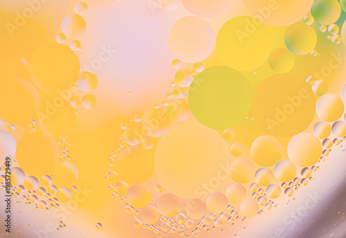 Abstract macro texture with translucent orange, yellow, and green bubbles, soft pastel background, smooth gradients