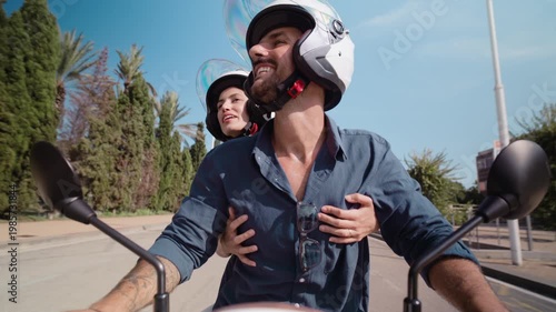 Video of beautiful and happy couple riding around the city on a motorbike