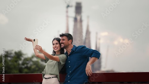 Video of beautiful couple taking photos of themselves with smartphone in the city