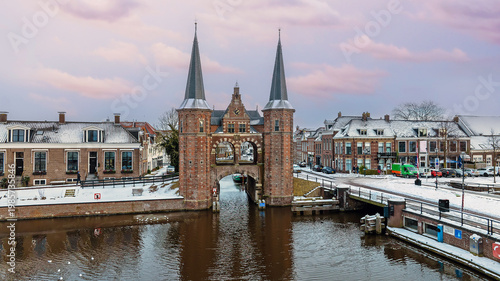 Aerial View of Snowy Historic City with Landmark Gate in Winter