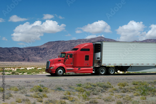 semi truck driving on highway through nature and mountains. Commercial vehicle transport for logistics and freight shipping.