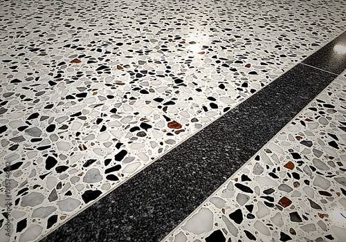 Black and white terrazzo floor with black stripe