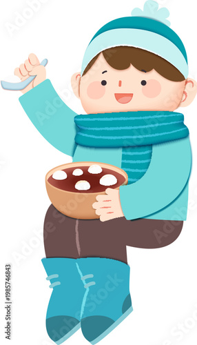Asian boy dressed in winter costume eating tangyuan
