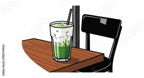A tall glass with green liquid and a straw sits on a wooden table next to a chair