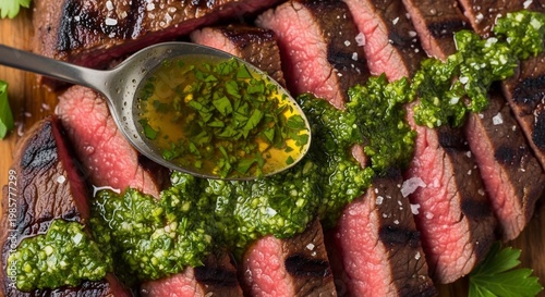Delicious Grilled Flank Steak Sliced and Topped with Fresh Chimichurri Sauce.