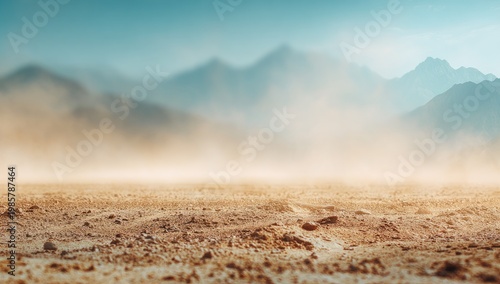 Dust cloud billows over dry desert ground, with blurred mountains under a hazy blue sky
