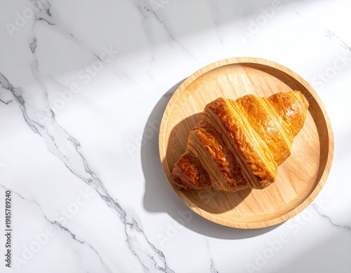 Wallpaper Mural Golden croissant on wood plate, marble background Torontodigital.ca