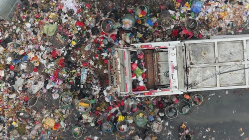 Garbage truck unloading at overcrowded landfill in jakarta