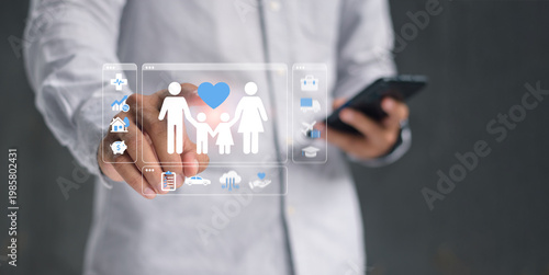 Businessman touches a holographic interface of family life insurance, finance, and investment icons, illustrating proactive digital planning and positive future security