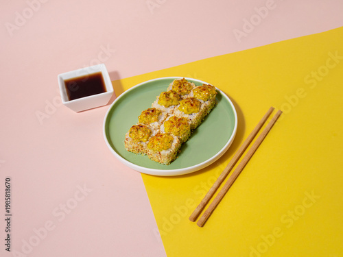 Refined sushi featuring crispy topping on vibrant plate with condiments