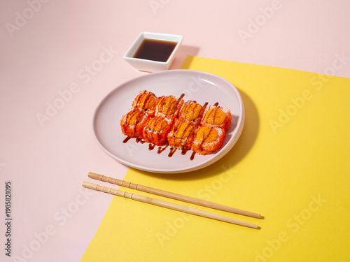 Closeup image showcasing glazed salmon sushi with dipping sauces