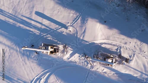 Oil Pumpjack Working in Snowy Field Aerial Top View