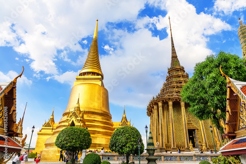 Stunning view of Wat Phra Kaew in Bangkok, Thailand, featuring golden stupas and intricate temple architecture.